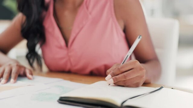 Woman, hands and writing business idea, planning or strategy in book for record keeping or reminder at office. Hand of creative female fashion designer taking notes for startup plan on workshop desk