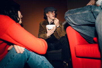 UGC pf three young people eating taking  