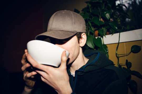 UGC young man drinking from bowl 