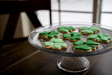 Green Frosted Shamrock Cookies on Glass Plate in Window LIght