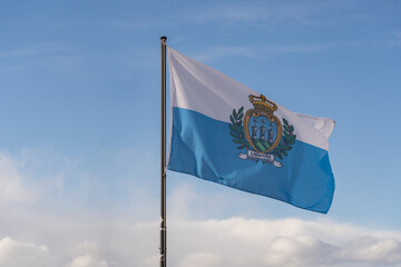 San Marino national flag cloth fabric waving on the sky