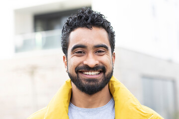 portrait of a young man with short hair outside