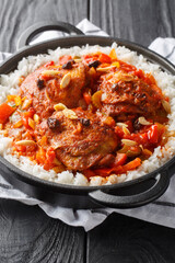 Country captain is a curried chicken and rice dish, which is popular in the Southern United States closeup on the pan on the table. Vertical