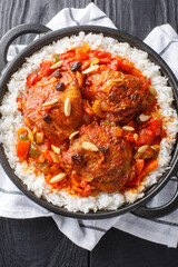 Country captain is a curried chicken and rice dish, which is popular in the Southern United States closeup on the pan on the table. Vertical top view from above