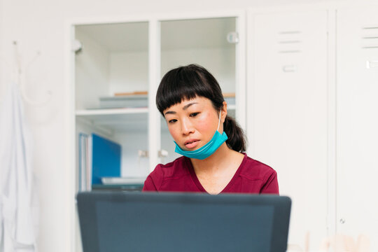 Female Doctor Working at Computer 