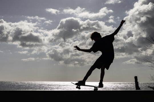Silhouetted skateboarder