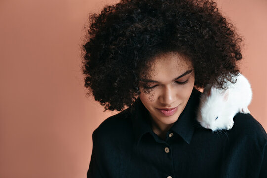 Beautiful woman with white pet rabbit.