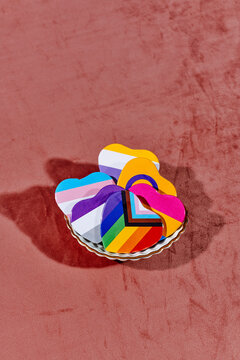 some heart-shaped badges with different LGBTIQ flags