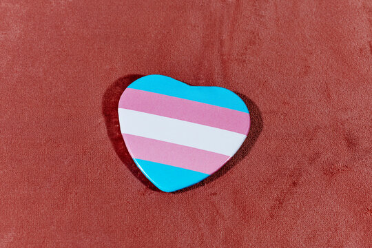 transgender pride flag in a heart-shaped badge