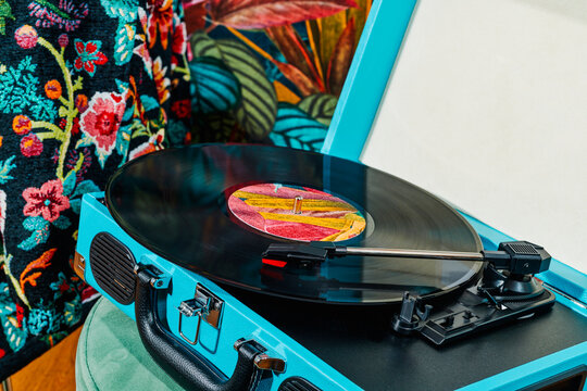 record being played in a blue portable turntable