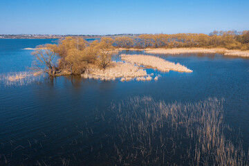 An aerial panoramic view on a lake in early spring time