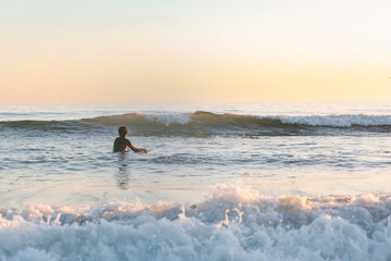 Teen boy enjoying at the ocean in cold west coast California