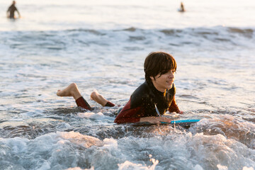 Teen boy practicing surf by the west coast