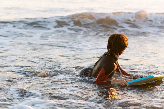 Teenager surfing at the beach 