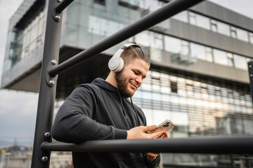 One man caucasian young male stand at outdoor open training park gym