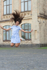 Fototapeta na wymiar childhood happiness of glad teen girl outdoor. childhood happiness of teen girl jumping outside