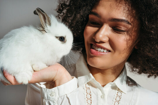 Close-up smiling woman with rabbit.