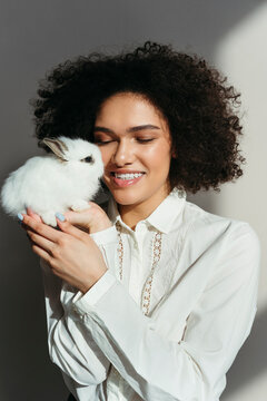 Beautiful smiling woman with rabbit.