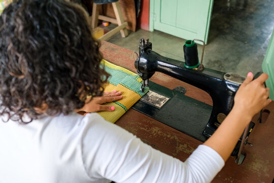 Person working on old sewing machine