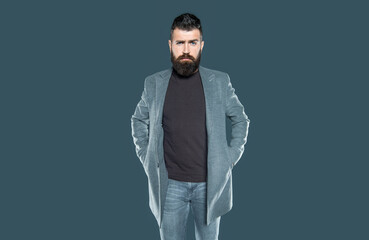 bearded ambitious man in casual on grey background