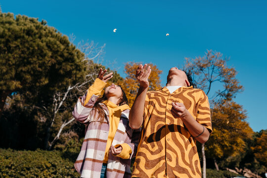 Friends throwing nuts on the air
