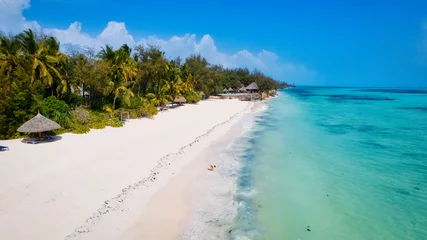 Foto op Plexiglas The warm weather and calm waters make Zanzibar beach summers a popular destination for water sports enthusiasts. © Sebastian