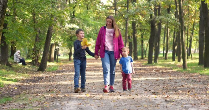 Happy family enjoying walk outdoors in the park. Family on autumn walk