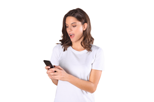Young woman dressed in basic clothing isolated on beige background, using mobile phone