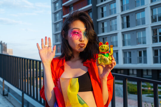 Asian Model With Maneki Neko Statuette