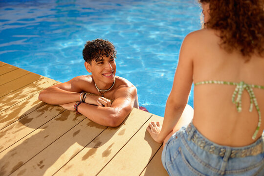Young couple spending time near pool