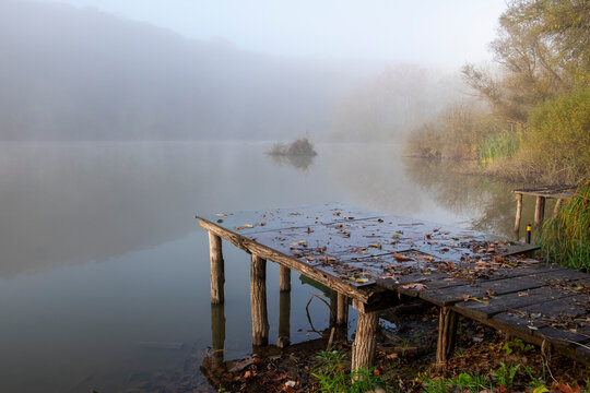 Autumn scene with foggy lake