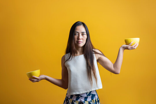 Woman lifting a melon cut in half