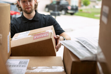 Shipment: Man Getting Boxes Out Of Delivery Van