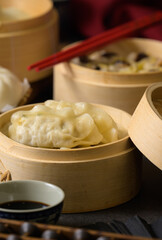 Chinese steamed pork shumai. Bamboo steamers with assorted dim sum, Chinese cuisine