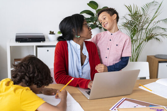 Boy thanking mother for help with homework