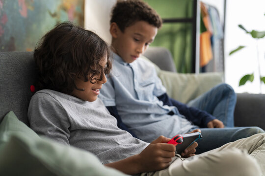 Boys playing video game on gaming console
