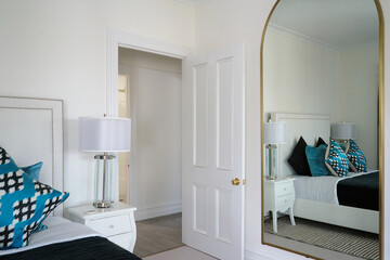 Large mirror in styled bedroom interior 