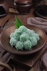 Klepon or kelepon, is a snack of sweet rice cake balls filled with molten palm sugar and coated in grated coconut. Of Javanese origin, the green-coloured glutinous rice balls 