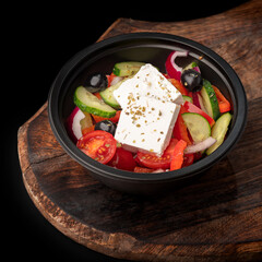 Fresh Greek salad with pepper, tomato, olive, feta cheese, cucumber, lettuce, oil. To Go Salad