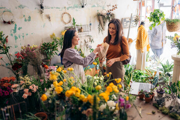 Florist selling plants and flower to client