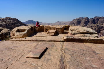 Motab or Throne of the Deity Altar at the High Place of Sacrifice in Petra, Wadi Musa, Jordan with Bedouin Woman