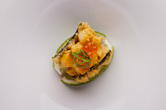 Nikkei Taco with Smoked Aji Pepper Sauce on white dish