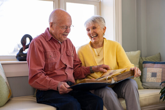 Senior Citizen couple at home Looking at photo album 