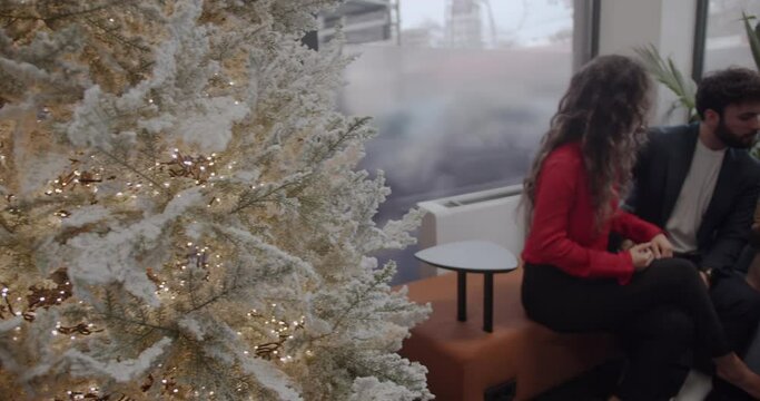 Young diverse colleagues are celebrating success at work during a christmas time, modern office space, panning