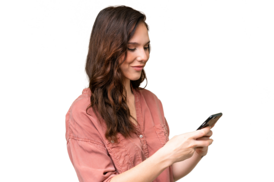 Young caucasian woman over isolated background sending a message or email with the mobile