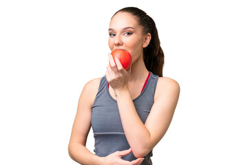 Young caucasian woman over isolated background eating an apple