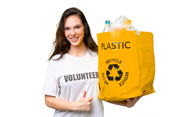 Young caucasian woman holding a bag full of plastic bottles to recycle over isolated background with thumbs up because something good has happened