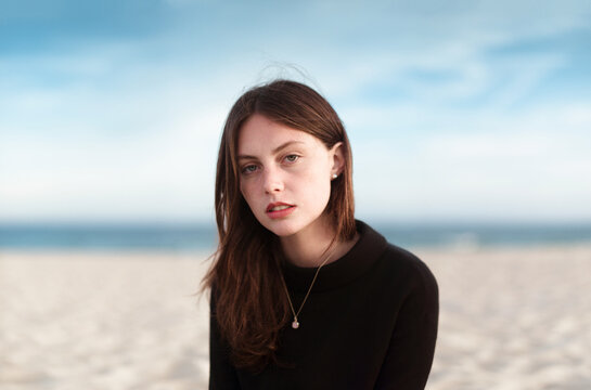 Portrait of stylish woman sitting at the beach - Powered by Adobe