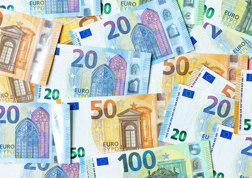 Group of money EURO banknotes arranged in a chaotic manner. EURO banknotes isolated on pink background. Exchange money, EURO money, Cash, Finances,Travel concept, Money background, EURO currency.