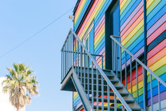 Rainbow colored buildings and sunny sky.